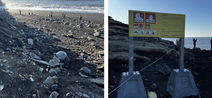 Schwarzer Sandstrand mit Warnschild.